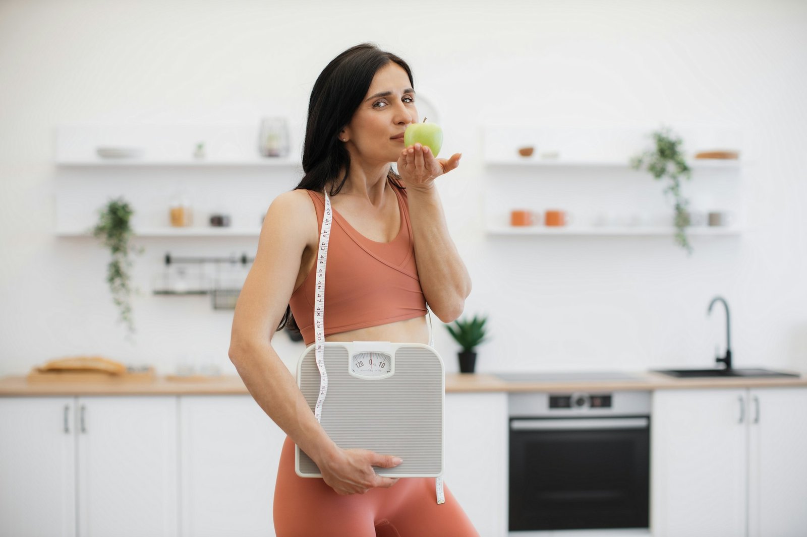 Adult with scales relishing weight loss with apple at home